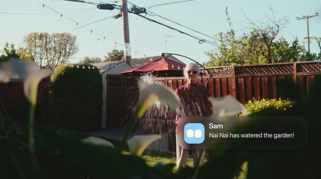 A grandma watering the flowers in her garden.
