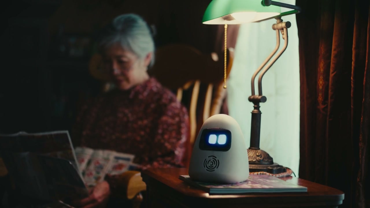 A grandma reading beside Sam and a green reading lamp.