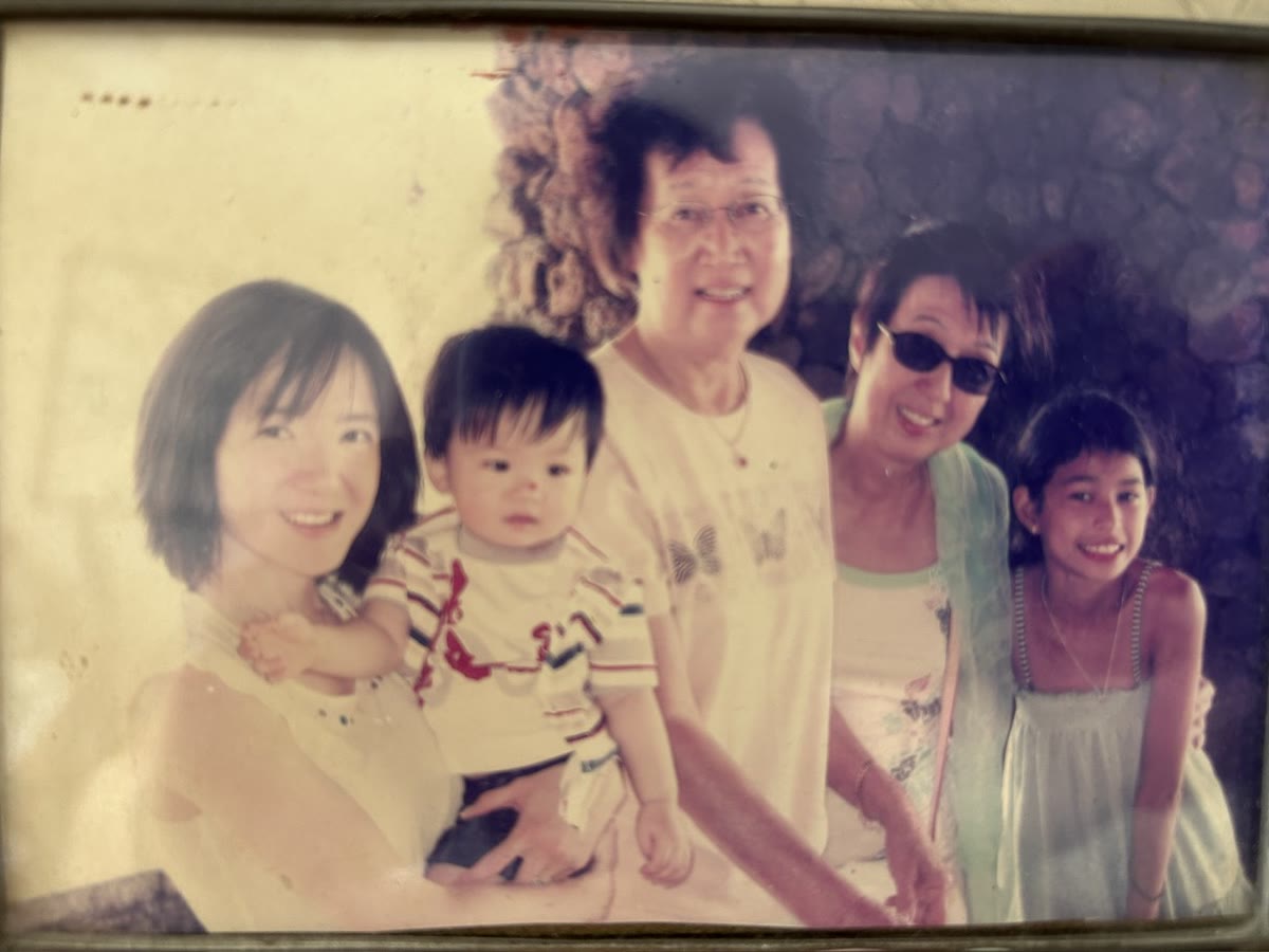 A childhood family photograph with three generations together.