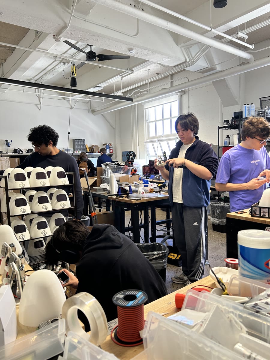 The team assembling Sam robots in the workshop.
